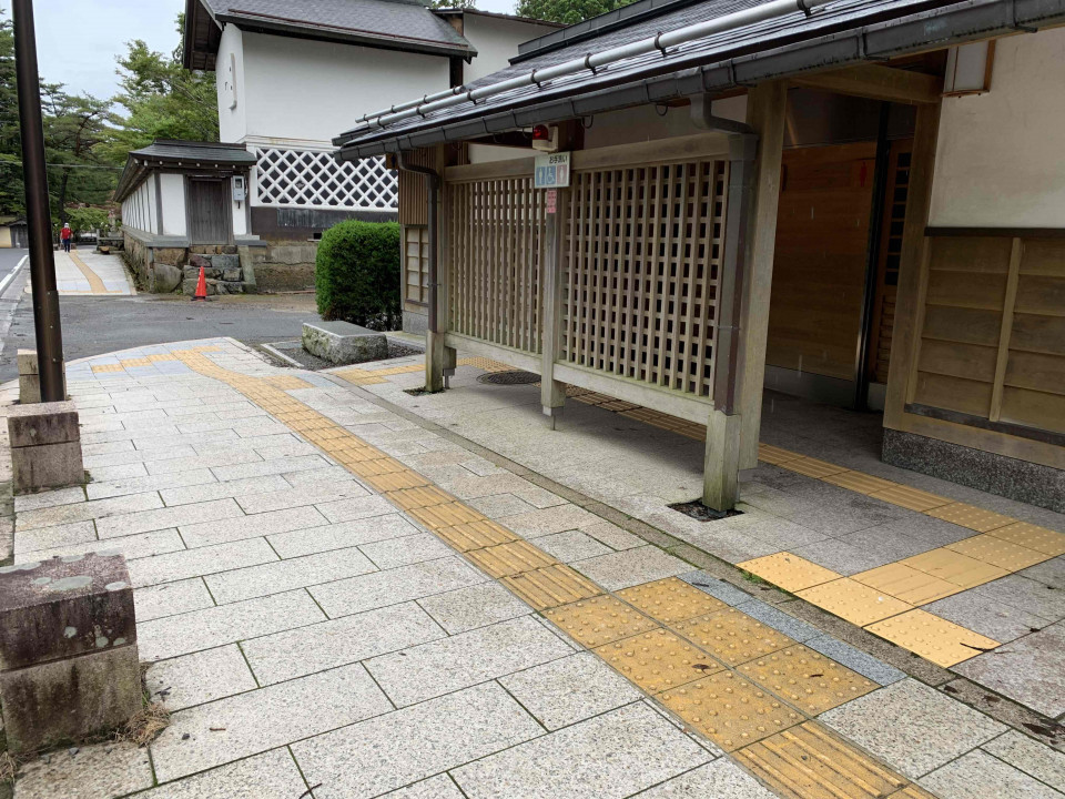 There is braille tiling for the blind on the pavement leading to the accessible restroom at Chu-mon-mae.